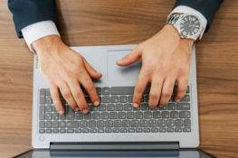 a-person-types-on-a-laptop-at-a-desk-.jpg A person types on a laptop at a desk.